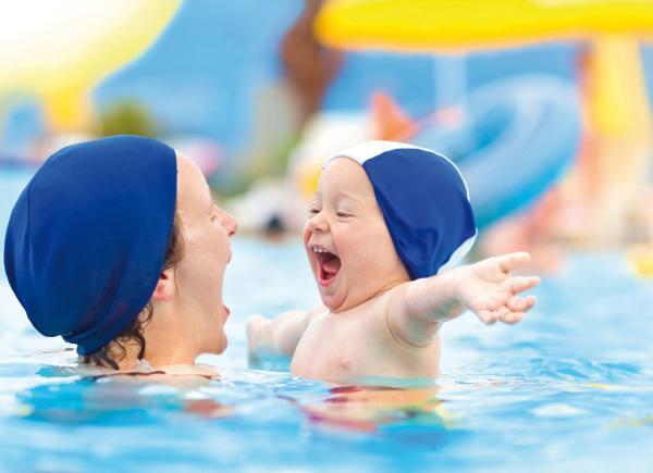 happy child mom swimming pool cap fun hug summer sea
