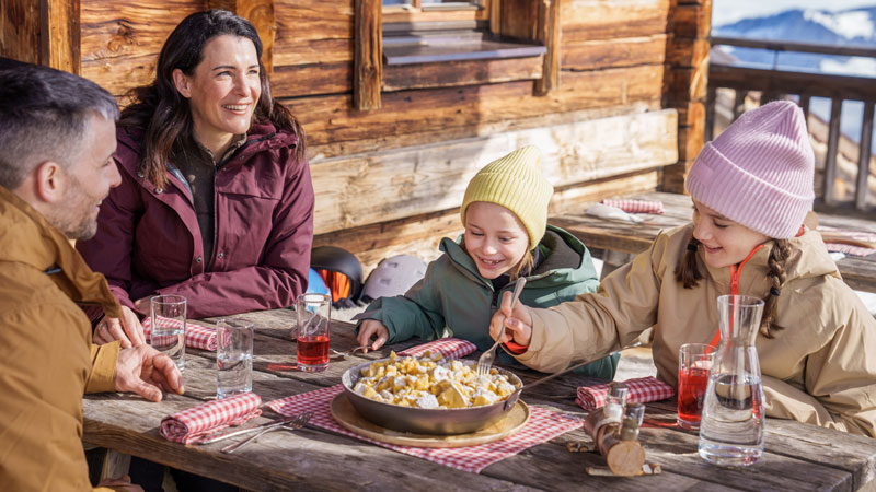 Familie-geniesst-Kaiserschmarrn-auf-Huette-im-Skigebiet-Ski-Juwel-Alpbachtal-Wildschoenau.Bild.Oesterreich-Werbung_Christoph-Oberschneider.